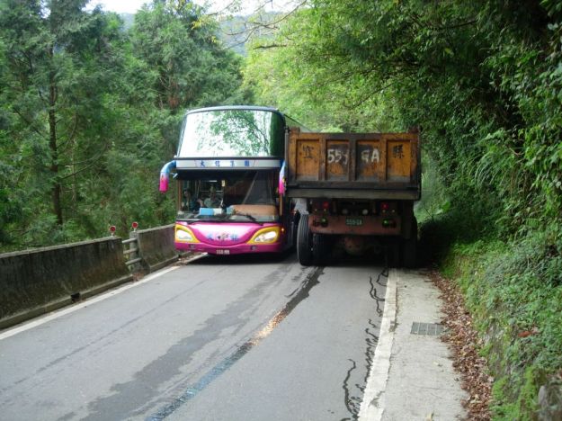 Bus and truck pass each other on a narrow section of the northern cross island highway in Taiwan