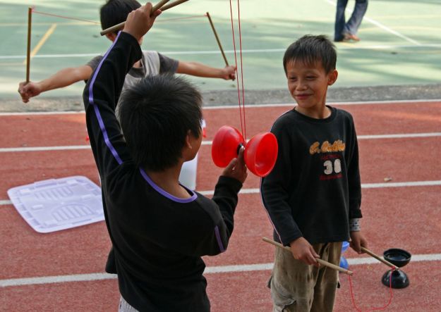 Boys playing with diabolo