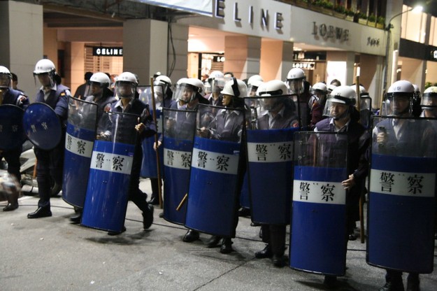 Riot police move forward